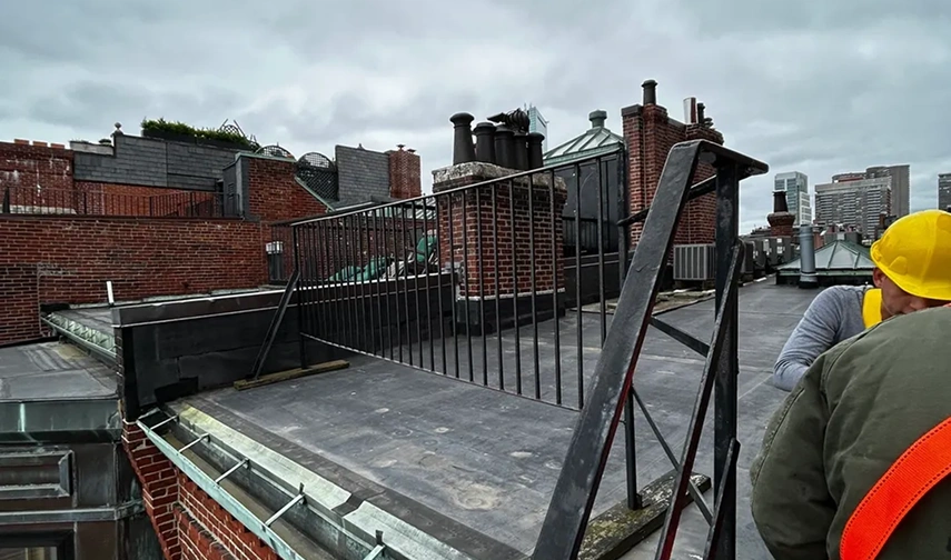 Rooftop with workers and city skyline.