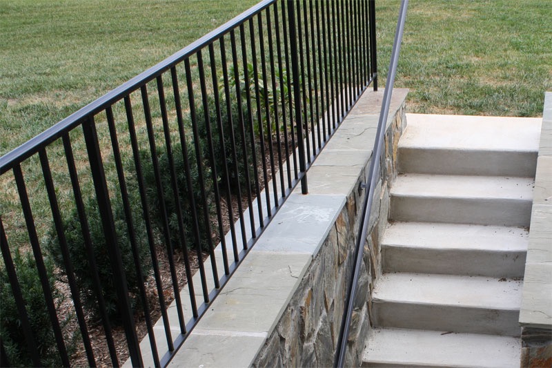 Concrete outdoor steps with black metal railing