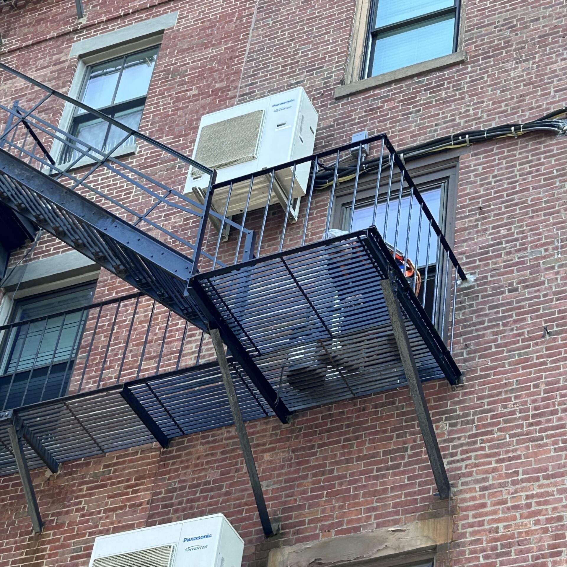 Brick building fire escape with window air conditioners